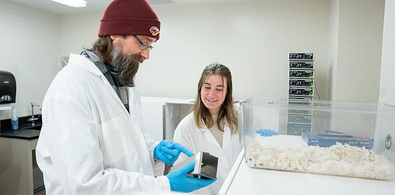 Katt Teles '24, a neuroscience major, and Stephen Robertson, assistant professor of psychology, work together in the lab.